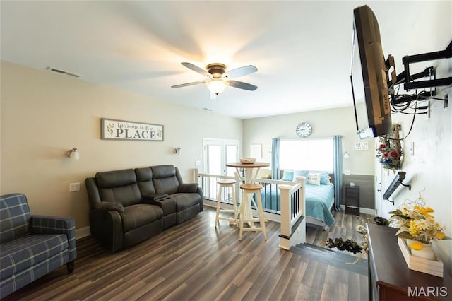 living room with ceiling fan and wood finished floors