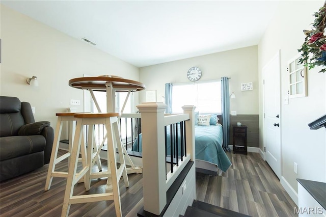 bedroom with wood finished floors and baseboards