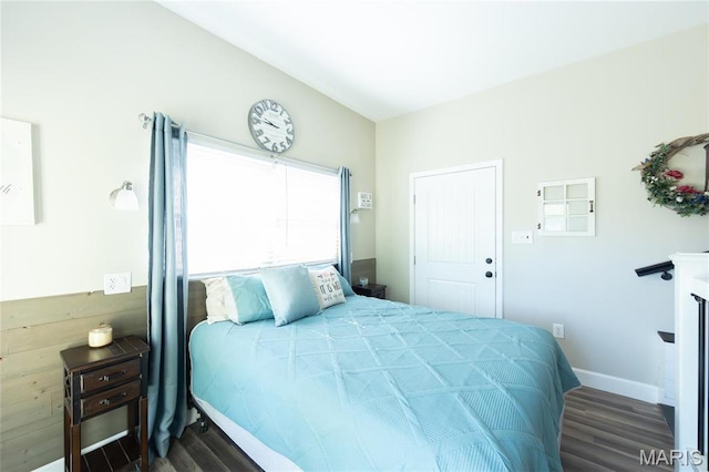 bedroom featuring wood finished floors and baseboards