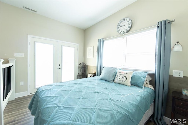 bedroom with wood finished floors and french doors