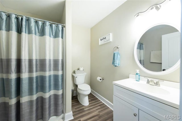bathroom with wood finished floors, toilet, vanity, baseboards, and a shower with shower curtain