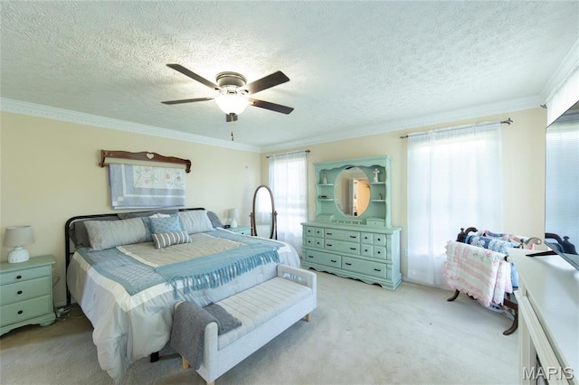bedroom with light carpet, ornamental molding, a ceiling fan, and a textured ceiling