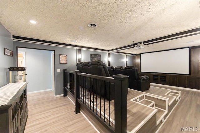 home theater room with a textured ceiling, light wood-type flooring, baseboards, and recessed lighting