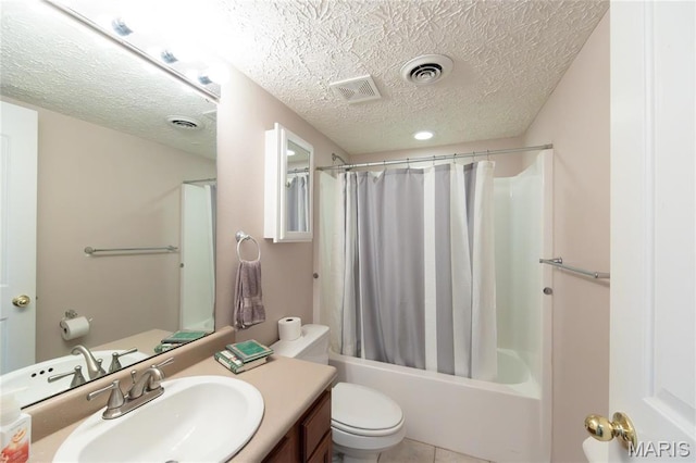 bathroom featuring toilet, a textured ceiling, shower / bath combination with curtain, vanity, and tile patterned flooring