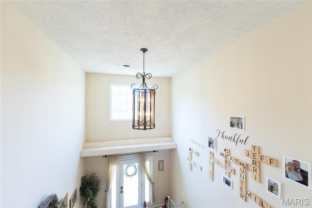 detailed view of a textured ceiling and a chandelier