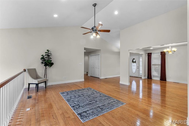 2600 Cobblestone Ct, Cape Girardeau, MO 63701 - unfurnished living room with ceiling fan, a chandelier, light wood finished floors, baseboards, and high vaulted ceiling