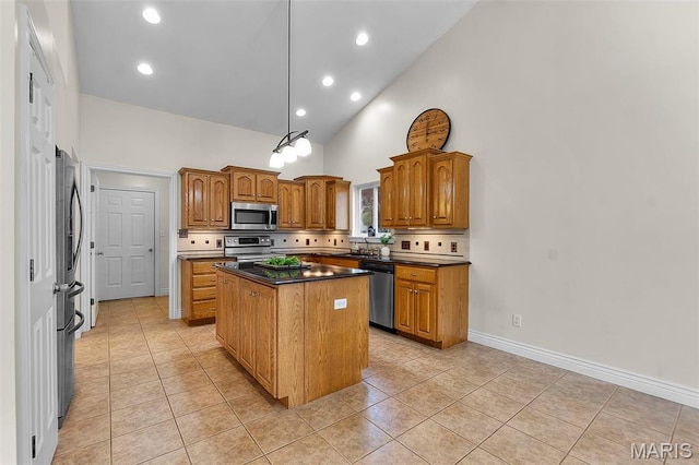 2600 Cobblestone Ct, Cape Girardeau, MO 63701 - kitchen with stainless steel appliances, a center island, dark countertops, brown cabinetry, and light tile patterned floors