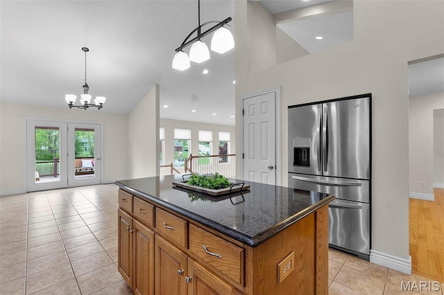 2600 Cobblestone Ct, Cape Girardeau, MO 63701 - kitchen with stainless steel fridge with ice dispenser, brown cabinetry, a center island, baseboards, and a chandelier
