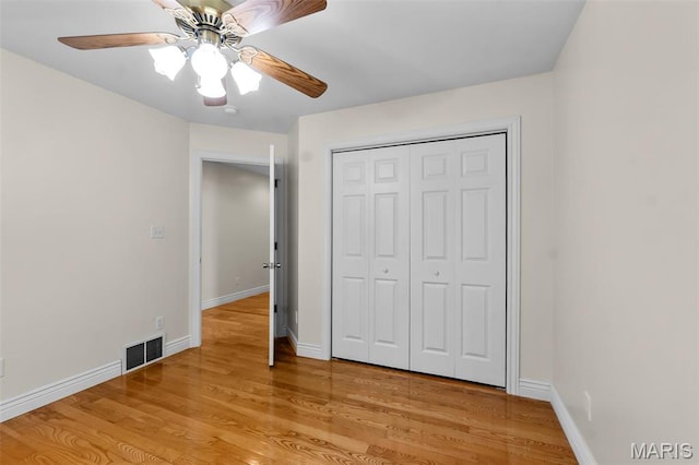 2600 Cobblestone Ct, Cape Girardeau, MO 63701 - unfurnished bedroom with light wood finished floors, baseboards, a closet, and a ceiling fan