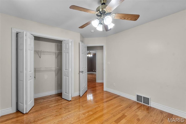 2600 Cobblestone Ct, Cape Girardeau, MO 63701 - unfurnished bedroom with light wood-style flooring, a closet, baseboards, and a ceiling fan