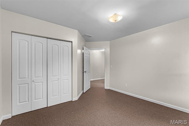 2600 Cobblestone Ct, Cape Girardeau, MO 63701 - unfurnished bedroom featuring dark carpet, baseboards, and a closet
