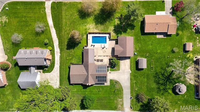 aerial view of property and surrounding area featuring a pool area