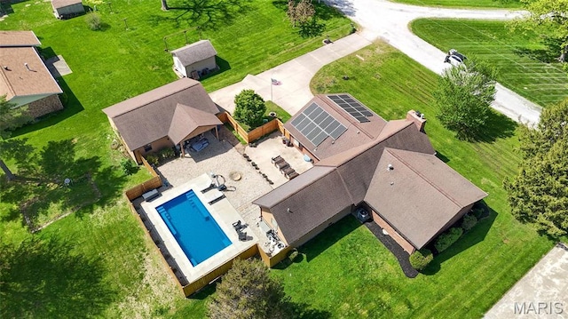 aerial view of property and surrounding area featuring a pool