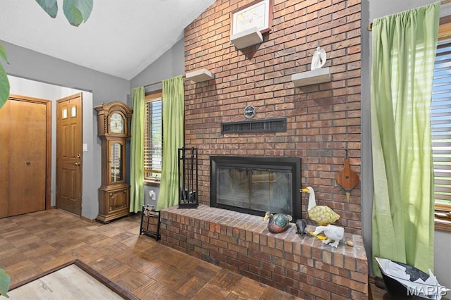 living room featuring lofted ceiling and a fireplace