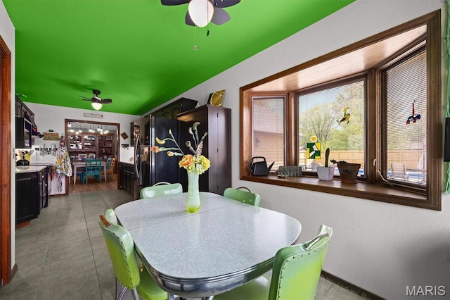 dining room featuring a ceiling fan and tile patterned flooring