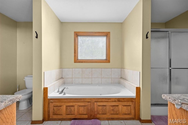 bathroom featuring vanity, toilet, a bath, tile patterned floors, and a shower stall