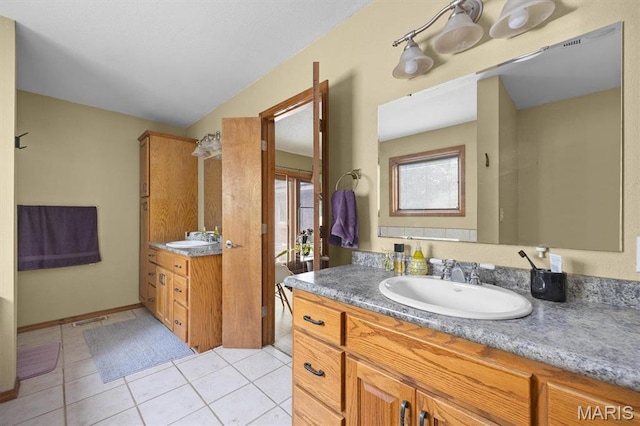 full bath featuring two vanities and tile patterned flooring