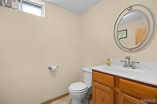 bathroom featuring toilet and vanity