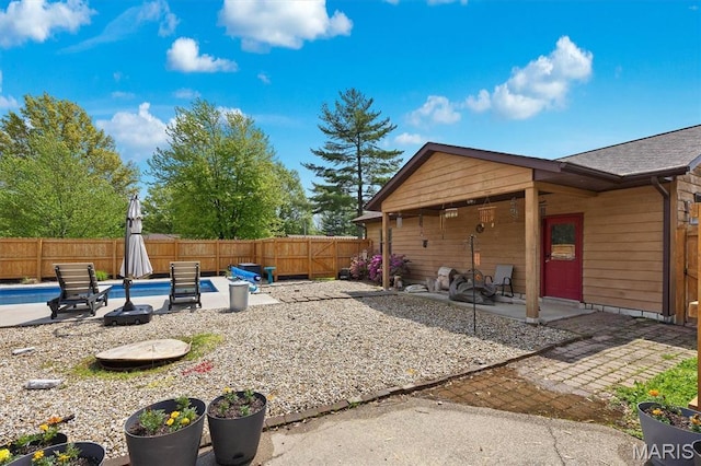fenced backyard with a patio area