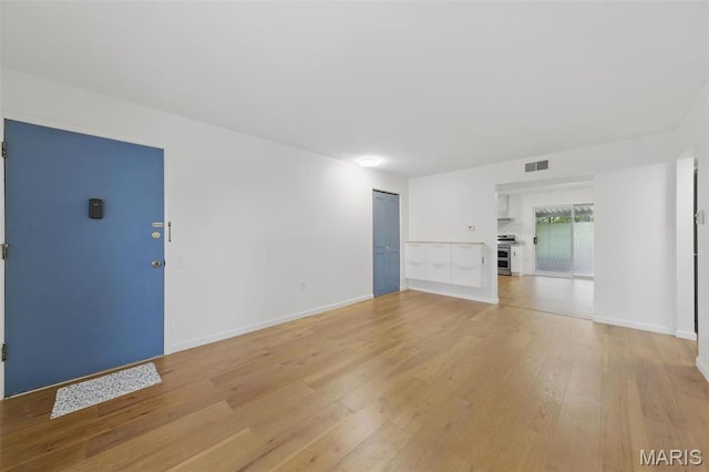 3214 Roger Williams Dr Unit D, Bridgeton, MO 63044 - unfurnished living room with light wood-style flooring and baseboards