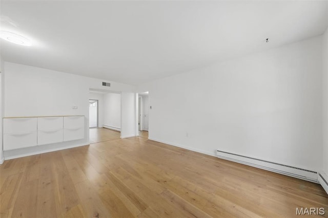 3214 Roger Williams Dr Unit D, Bridgeton, MO 63044 - spare room featuring light wood finished floors, a baseboard heating unit, and baseboards