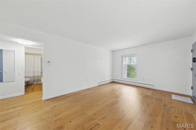 3214 Roger Williams Dr Unit D, Bridgeton, MO 63044 - unfurnished room with a baseboard heating unit, light wood-style flooring, and baseboards