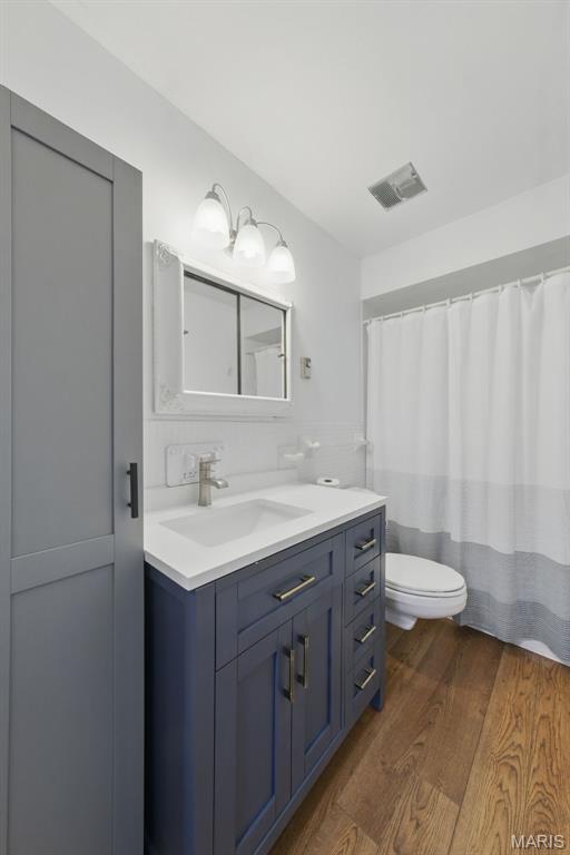 3214 Roger Williams Dr Unit D, Bridgeton, MO 63044 - bathroom with toilet, vanity, and wood finished floors