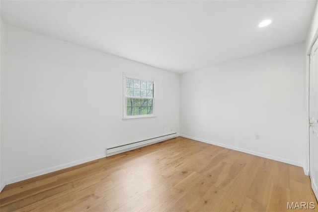 3214 Roger Williams Dr Unit D, Bridgeton, MO 63044 - spare room featuring a baseboard heating unit, light wood finished floors, baseboards, and recessed lighting