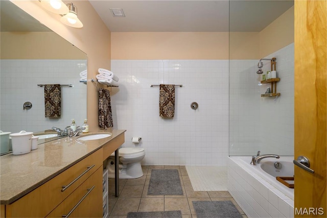 901 Washington Ave Unit 411, Saint Louis, MO 63101 - bathroom with tile walls, tile patterned floors, tiled bath, vanity, and toilet