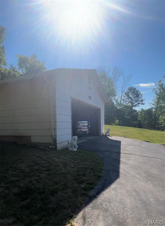 5904 Kneff Rd, Imperial, MO 63052 - view of home's exterior featuring asphalt driveway, a garage, an outdoor structure, and a yard