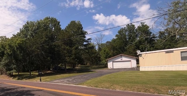 5904 Kneff Rd, Imperial, MO 63052 - view of front of house featuring a garage, an outdoor structure, a front lawn, and asphalt driveway