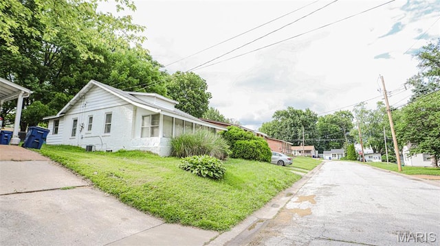view of property exterior with a yard