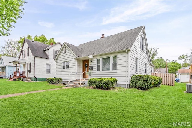 1404 Lemon St, Highland, IL 62249 - view of front of property with a front lawn, roof with shingles, and a chimney