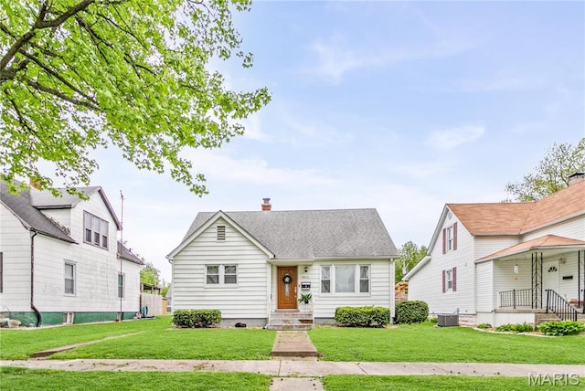 1404 Lemon St, Highland, IL 62249 - view of front of home featuring a chimney and a front yard