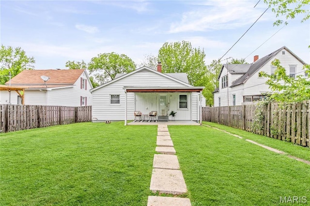 1404 Lemon St, Highland, IL 62249 - back of property featuring a patio, a fenced backyard, and a chimney