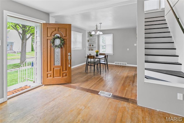 1404 Lemon St, Highland, IL 62249 - entryway with light wood-type flooring, a chandelier, and stairway