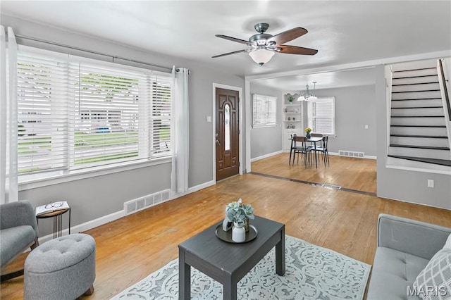 1404 Lemon St, Highland, IL 62249 - living room with ceiling fan, wood finished floors, stairs, and a chandelier