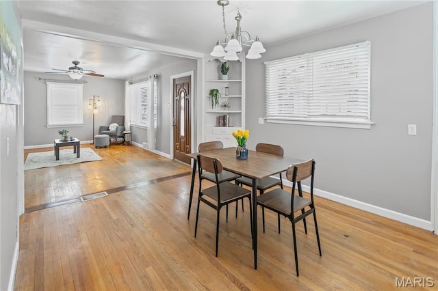 1404 Lemon St, Highland, IL 62249 - dining area with a chandelier, light wood-type flooring, and a ceiling fan