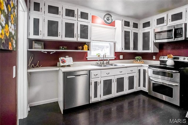 1404 Lemon St, Highland, IL 62249 - kitchen with appliances with stainless steel finishes, light countertops, white cabinetry, and glass insert cabinets