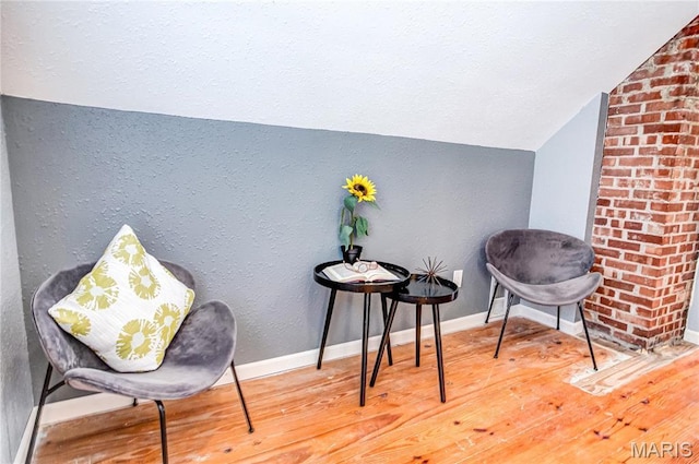 1404 Lemon St, Highland, IL 62249 - living area featuring vaulted ceiling, wood finished floors, and a textured wall