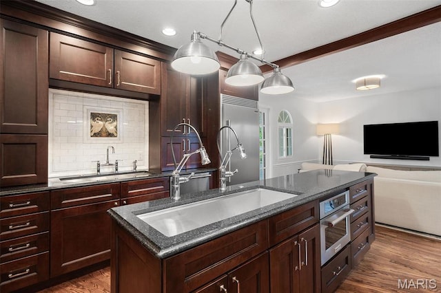 2 Northcote Rd, Saint Louis, MO 63144 - kitchen with a sink, an island with sink, tasteful backsplash, dark wood-style floors, and recessed lighting