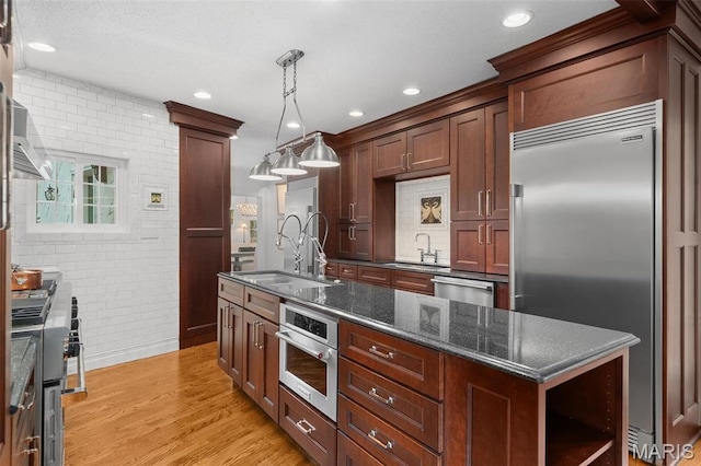 2 Northcote Rd, Saint Louis, MO 63144 - kitchen featuring high quality appliances, a sink, brick wall, open shelves, and light wood-style floors
