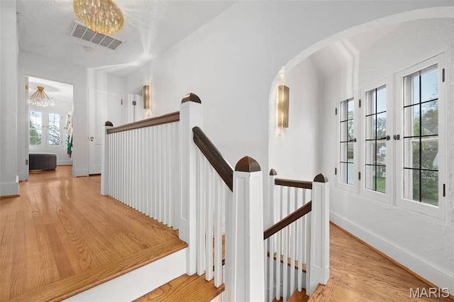 2 Northcote Rd, Saint Louis, MO 63144 - stairs with wood finished floors, baseboards, and arched walkways