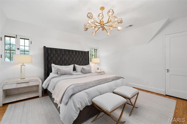 2 Northcote Rd, Saint Louis, MO 63144 - bedroom featuring a chandelier, wood finished floors, baseboards, and vaulted ceiling