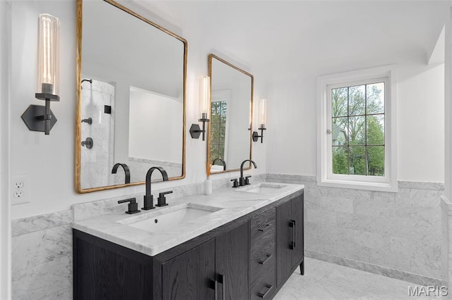 2 Northcote Rd, Saint Louis, MO 63144 - full bath featuring tile walls, wainscoting, and double vanity