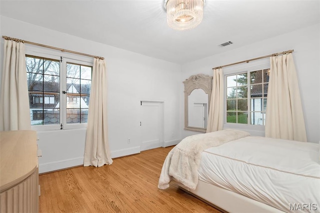 2 Northcote Rd, Saint Louis, MO 63144 - bedroom with light wood-type flooring, baseboards, and a chandelier