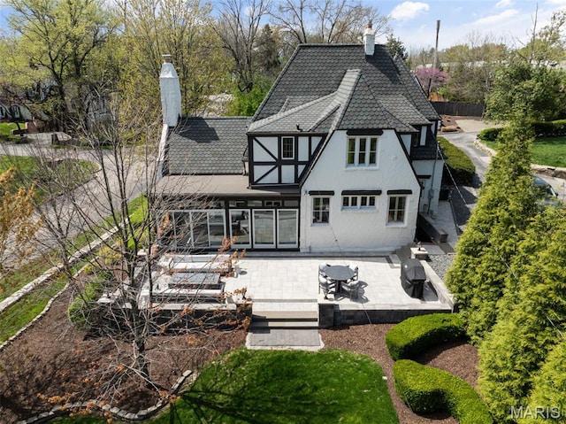 2 Northcote Rd, Saint Louis, MO 63144 - back of property with a chimney, stucco siding, and a patio
