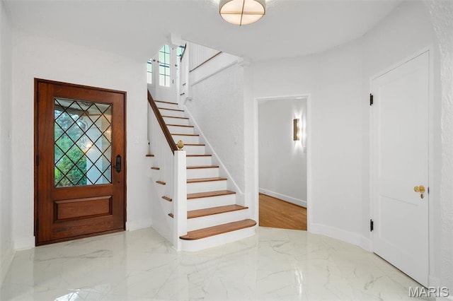 2 Northcote Rd, Saint Louis, MO 63144 - foyer entrance featuring marble tiled flooring, stairway, and baseboards