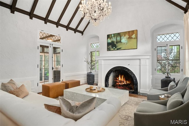 2 Northcote Rd, Saint Louis, MO 63144 - living area with high vaulted ceiling, a premium fireplace, a chandelier, arched walkways, and wood finished floors