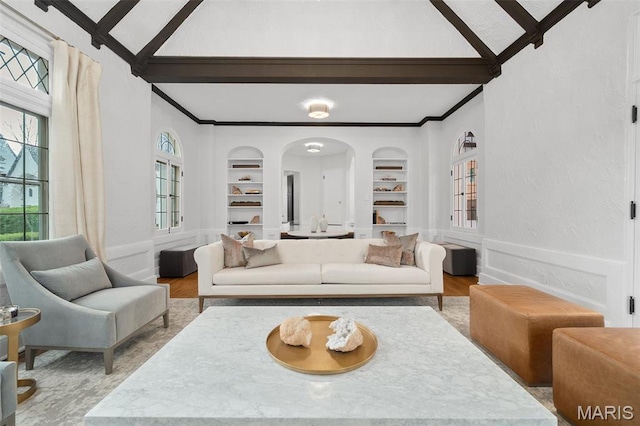 2 Northcote Rd, Saint Louis, MO 63144 - living area with wood finished floors, built in shelves, arched walkways, healthy amount of natural light, and ornamental molding